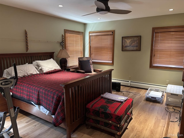 bedroom with a baseboard radiator, wood finished floors, recessed lighting, and a ceiling fan