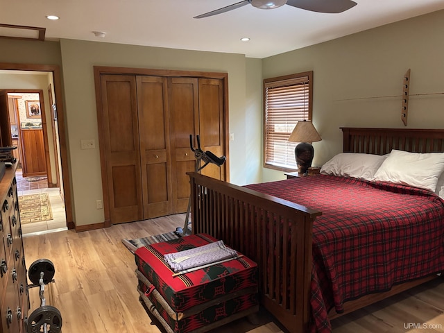 bedroom with light wood-type flooring, a closet, recessed lighting, ceiling fan, and baseboards