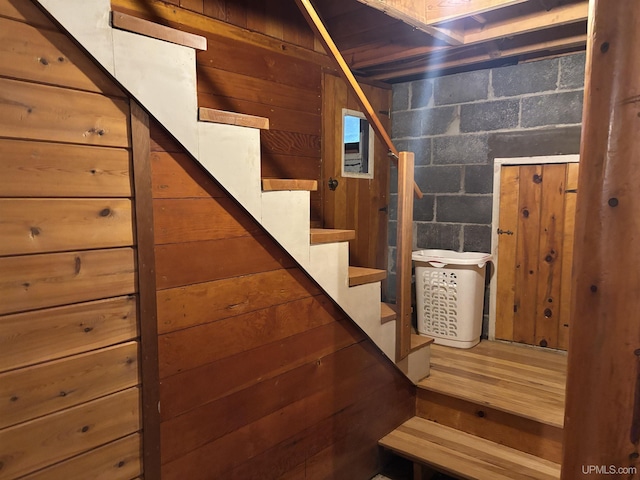 staircase with concrete block wall