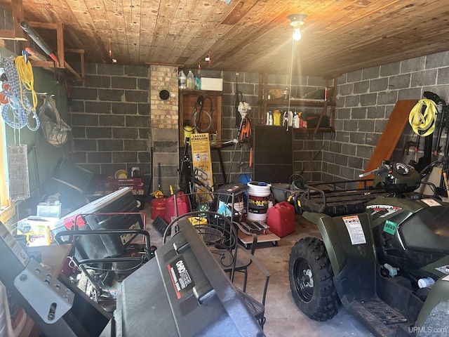 garage with wood ceiling and concrete block wall