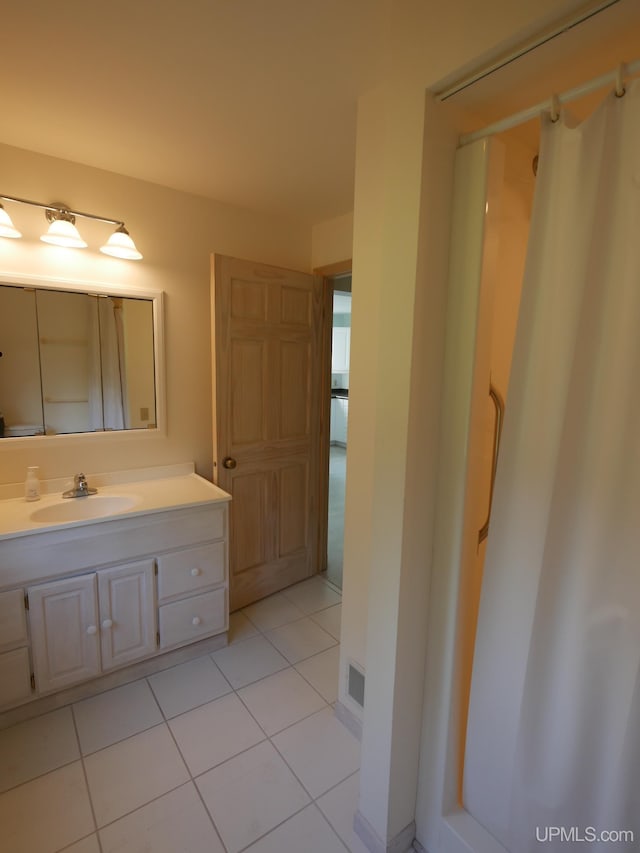 full bathroom with tile patterned floors and vanity