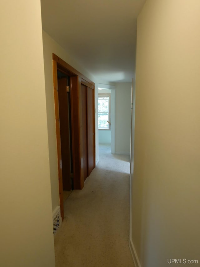 corridor with light carpet and visible vents