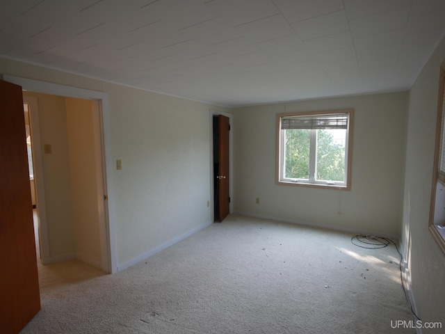 empty room featuring baseboards and carpet floors