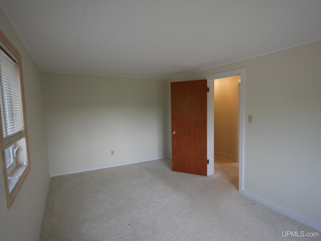 empty room featuring carpet floors and baseboards