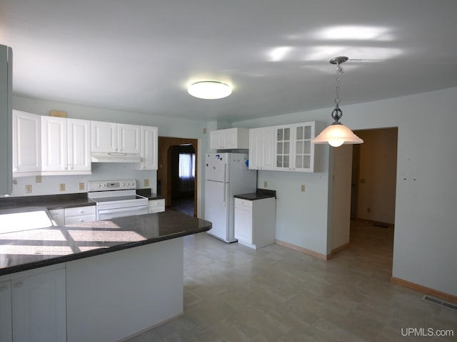 kitchen with white appliances, light floors, visible vents, under cabinet range hood, and dark countertops
