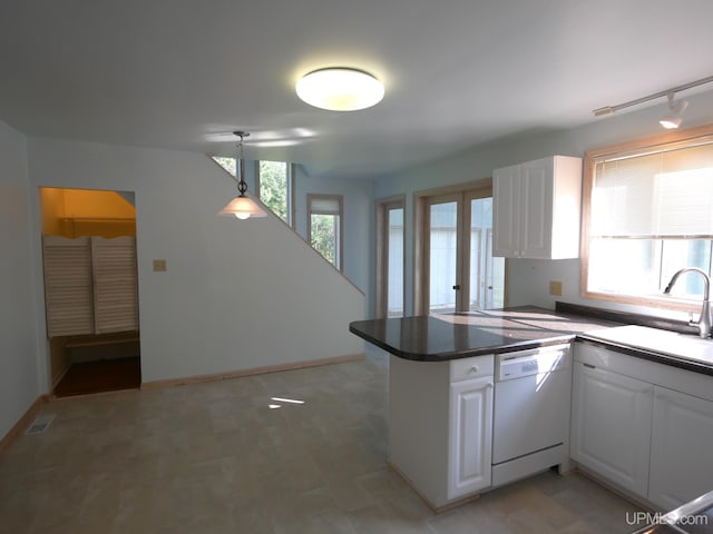 kitchen with white cabinets, a peninsula, a sink, and dishwasher