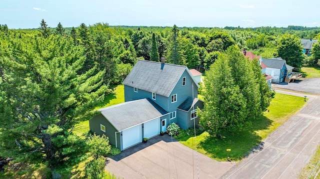 drone / aerial view featuring a wooded view
