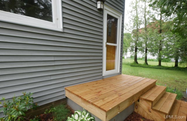 wooden deck featuring a lawn