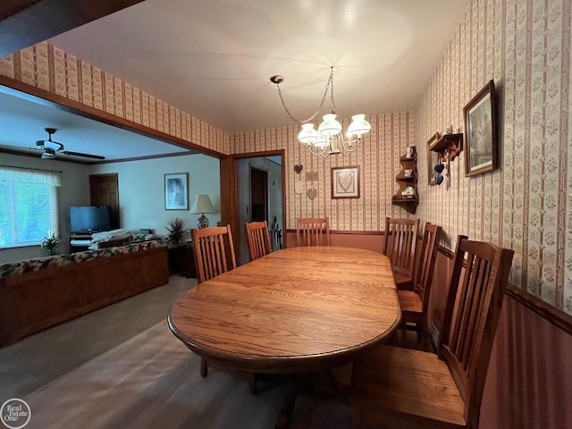 dining area featuring an inviting chandelier and wallpapered walls
