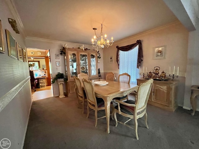 carpeted dining space with crown molding and a chandelier