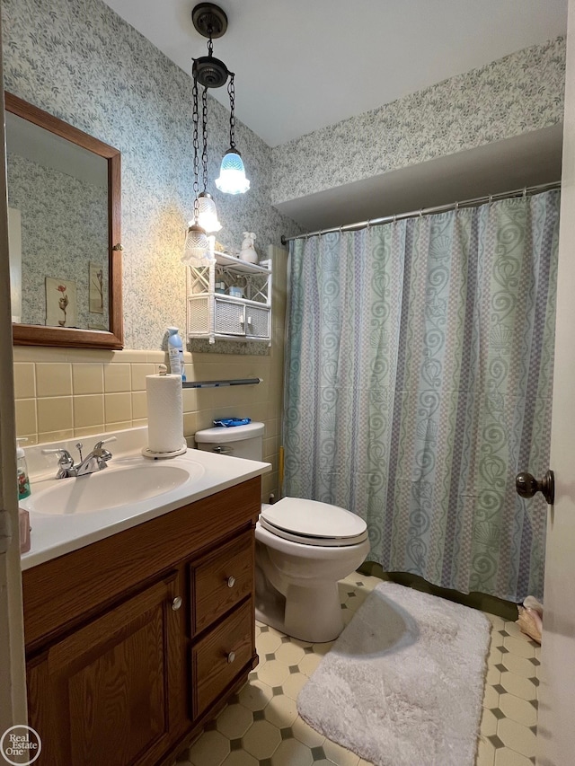 full bathroom with toilet, tile patterned floors, and vanity
