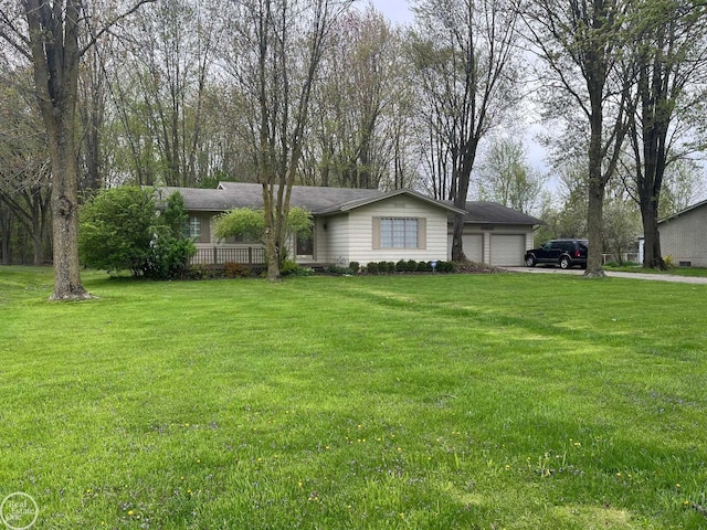 ranch-style house featuring a garage, a front lawn, and driveway