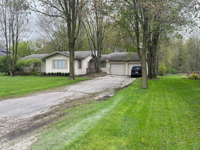 ranch-style home featuring aphalt driveway, a garage, and a front yard