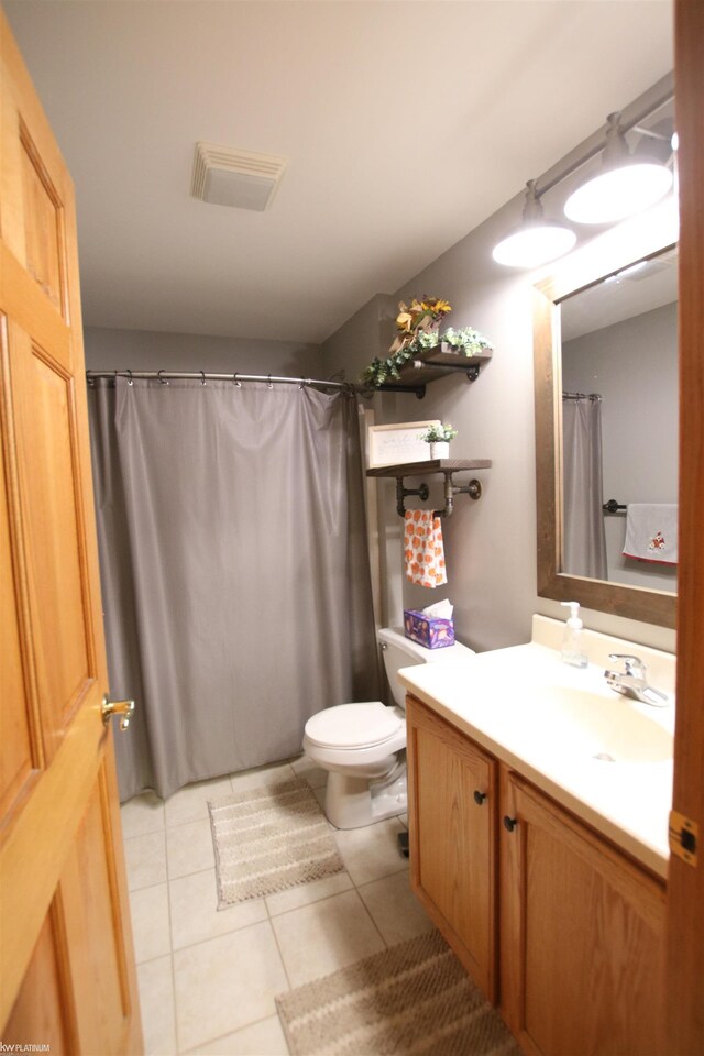 full bathroom featuring tile patterned flooring, toilet, and vanity