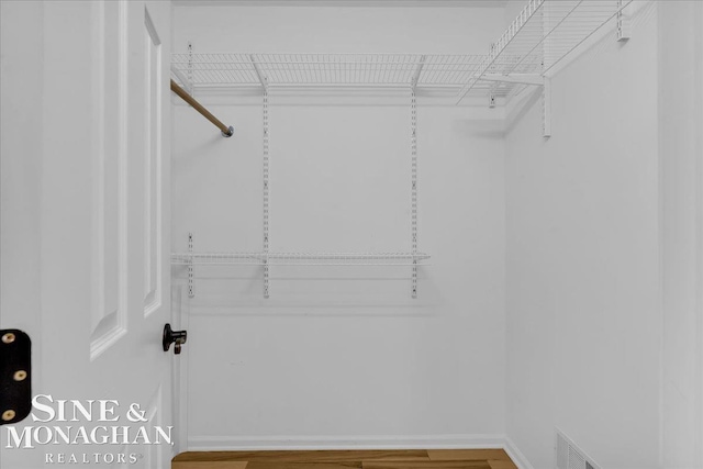 walk in closet featuring wood finished floors