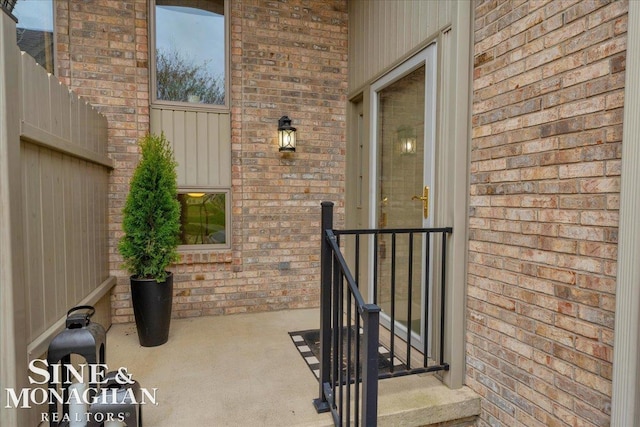 property entrance with brick siding
