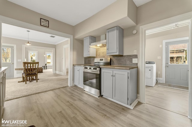 kitchen with light wood finished floors, electric range, baseboards, washer / dryer, and gray cabinetry