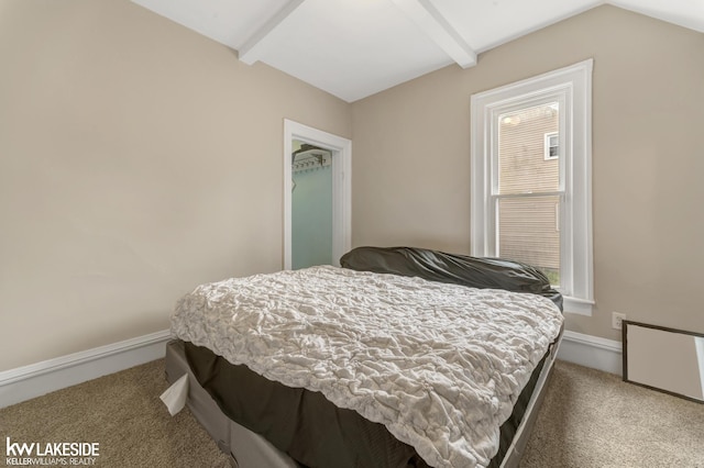 carpeted bedroom featuring baseboards and vaulted ceiling with beams