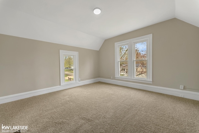 bonus room with carpet flooring, baseboards, and lofted ceiling