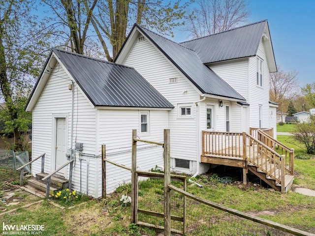 back of house with metal roof