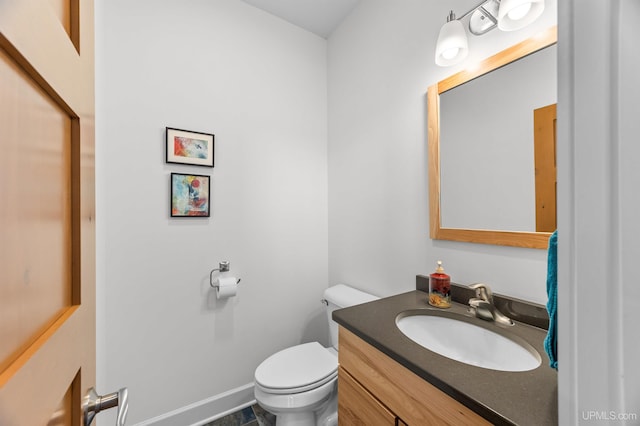 bathroom featuring toilet and vanity