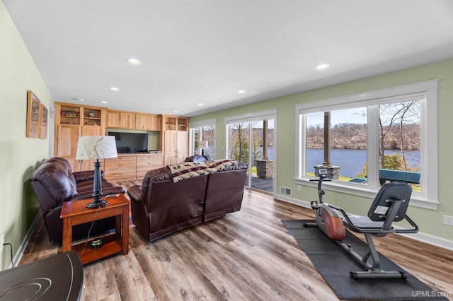 living room with baseboards, visible vents, recessed lighting, and wood finished floors
