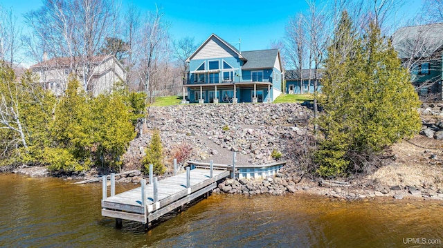 view of dock featuring a water view and a balcony