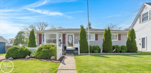 view of front of home with fence and a front yard