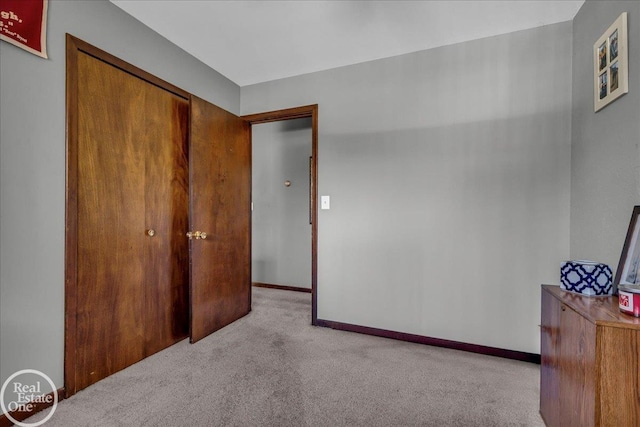 unfurnished bedroom with carpet floors and baseboards