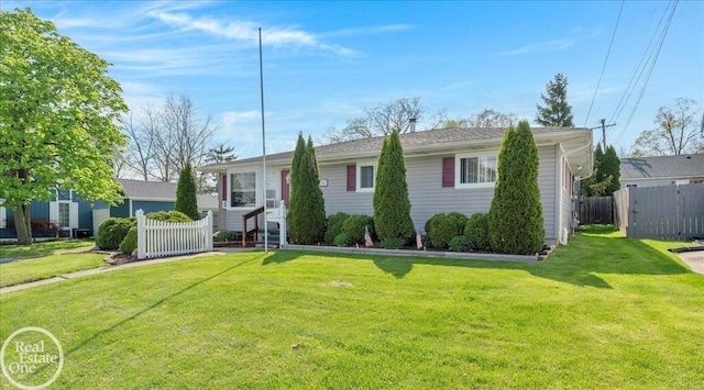 single story home with fence and a front yard