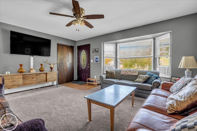 living room with ceiling fan and carpet floors