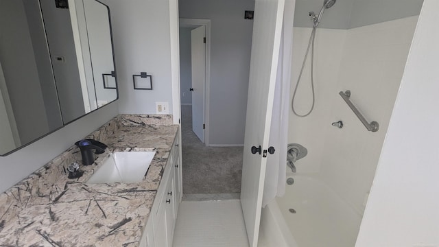 bathroom featuring washtub / shower combination and vanity