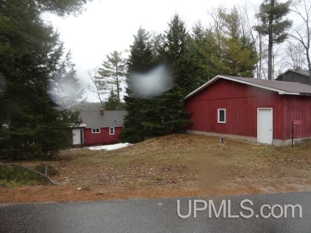 view of property exterior featuring an outbuilding