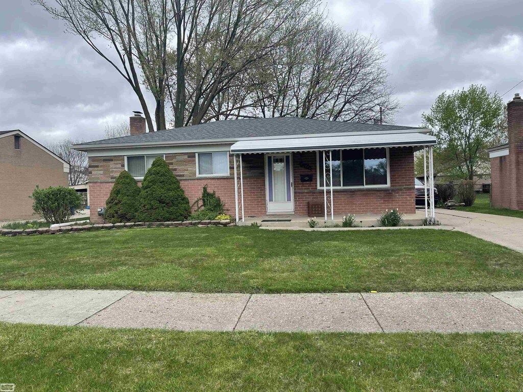 26746 Grobbel Ave, Warren, MI 48091 - ranch-style house with a chimney, a front yard, and brick siding