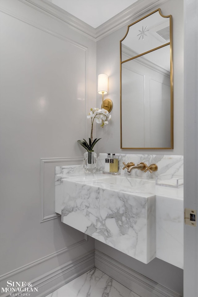 bathroom featuring crown molding and marble finish floor