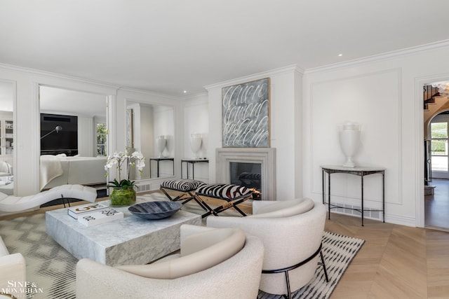 living room featuring recessed lighting, crown molding, visible vents, and a glass covered fireplace