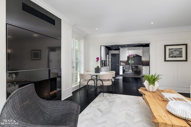 living area featuring crown molding and wood finished floors