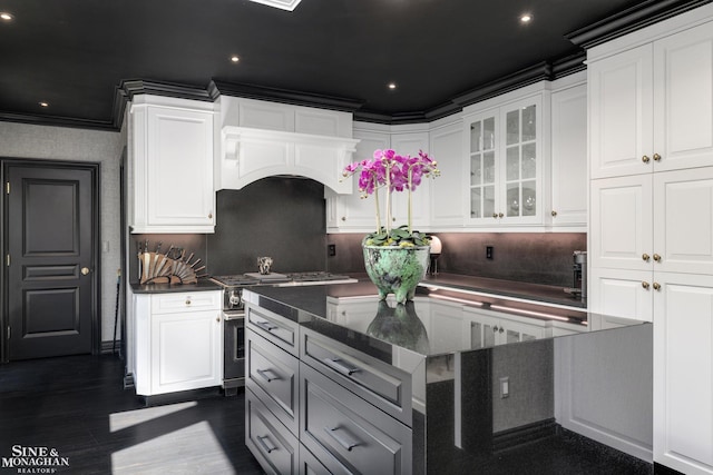 kitchen featuring white cabinetry, high end stainless steel range oven, dark wood-style flooring, and glass insert cabinets