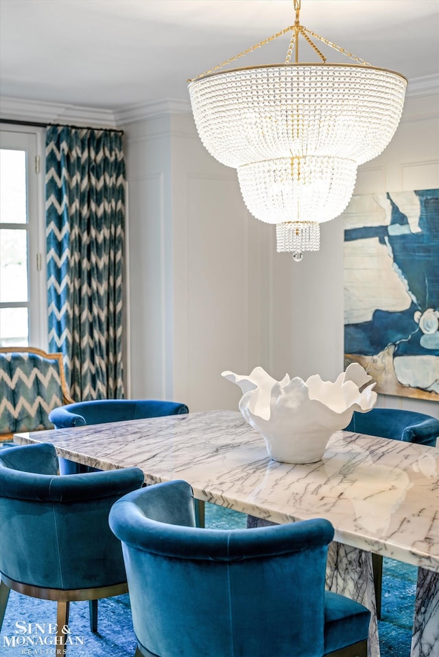 dining room featuring ornamental molding and a notable chandelier