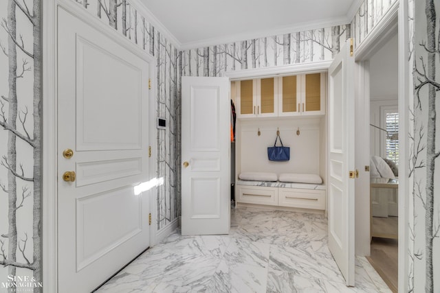 mudroom featuring marble finish floor and ornamental molding