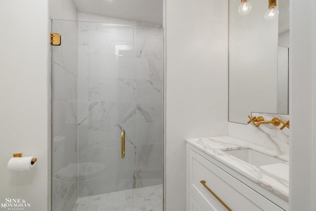 full bath featuring vanity and a shower stall