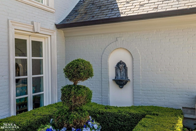 view of side of property with brick siding