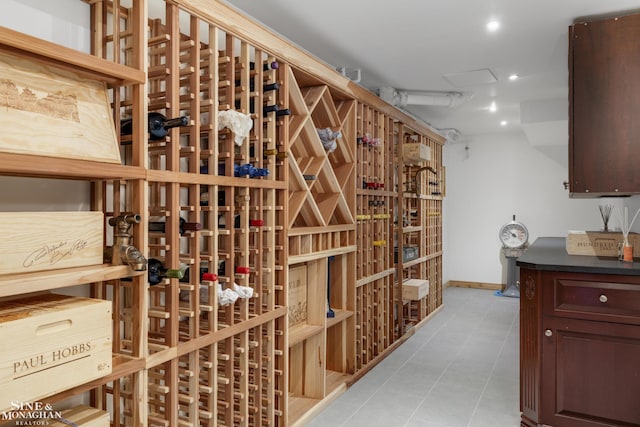 wine area with baseboards, light tile patterned floors, and recessed lighting