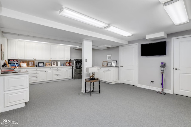 finished basement with carpet, baseboards, and refrigerator