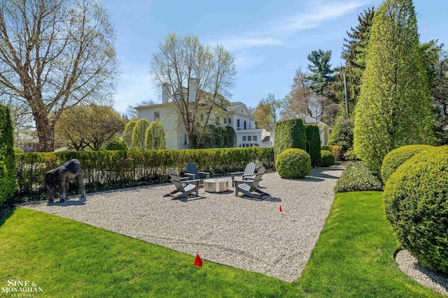 view of home's community featuring a fire pit and a lawn