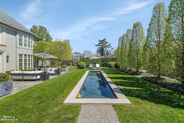 view of pool featuring an outdoor hangout area, a patio area, a fenced in pool, and a yard