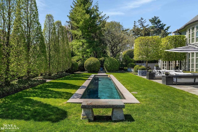 view of pool with an outdoor hangout area, a patio area, and a lawn