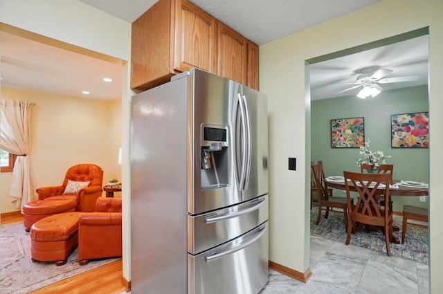 kitchen with baseboards, a ceiling fan, stainless steel refrigerator with ice dispenser, and recessed lighting