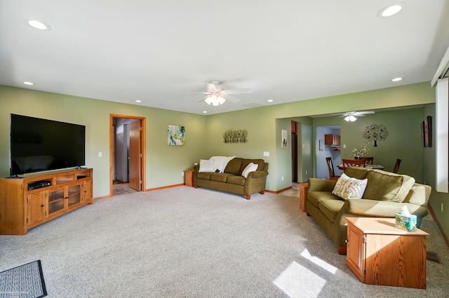 living area with light carpet, a ceiling fan, and recessed lighting