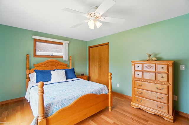 bedroom featuring baseboards and light wood finished floors